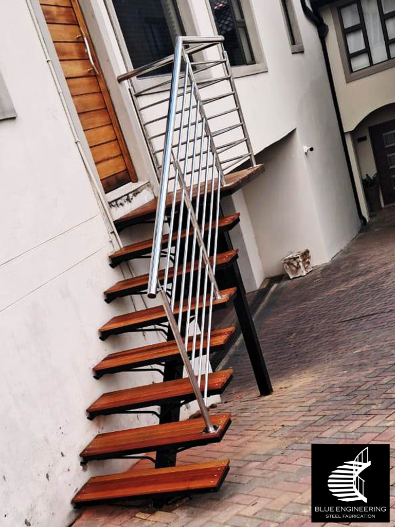 Mono Stringer Staircase with Balau Slat Timber Treads and Stainless Steel Balustreades. Blue Engineering supplies to Gauteng, Johannesburg, Pretoria, KwaZulu Natal, Durban, Western Cape, Capetown, South Africa